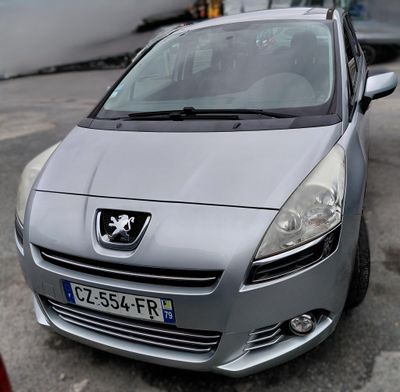 a silver car that is parked in a parking lot