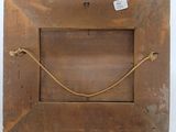an old wooden picture frame with a rope hanging from it ' s side