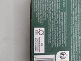 the back of a green box with a sticker on it