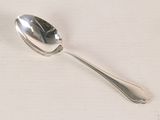 a silver spoon with a spoon handle on a white surface