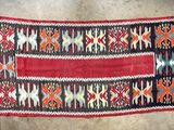 a red and black rug with a pattern on it
