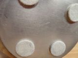 a close up of a metal object on a wooden surface