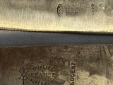 two knives that are sitting side by side on a table