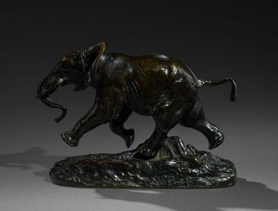 bronze statue of an elephant on a rock with a shadow on a gray background