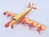 underside view of a red and yellow toy airplane on a white surface