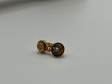 a close up of a pair of earrings on a white surface