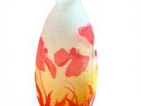 a glass vase with a red and yellow design on it