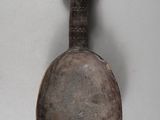a spoon with a face on it and a spoon with a face on it