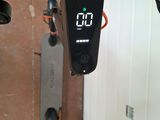 a clock on the handlebar of a scooter