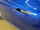 a close up of a car door handle with a sticker on it