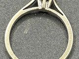 a close up of a ring with a diamond on it
