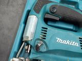 a blue box with a tool in it on the floor