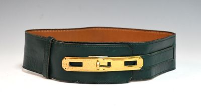 green leather belt with gold buckle on a white background
