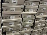 many boxes stacked on top of each other in a warehouse