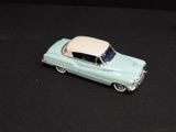 a toy car that is sitting on a black surface