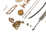 many different types of necklaces and bracelets on a white surface