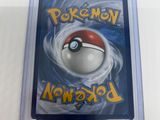 the pokemon card is in a plastic case on a white surface