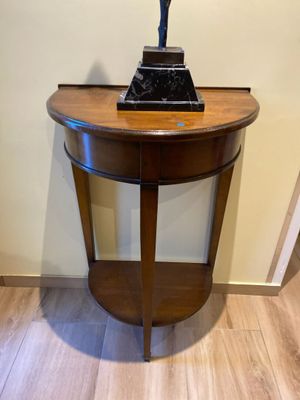 a small table with a statue on top of it