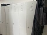 several lockers are lined up in a hallway with shoes on the floor
