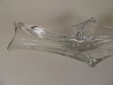 a glass bowl that is shaped like a boat