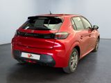 the rear end of a red car in a showroom