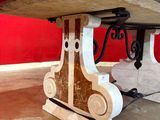 a table that has a bench underneath it in a room
