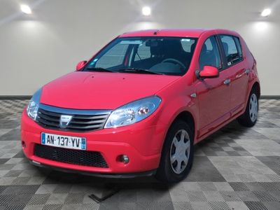 the small red car is parked in a large room
