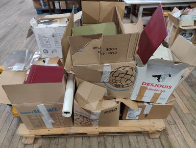 cardboard boxes stacked on top of each other on a wooden pallet
