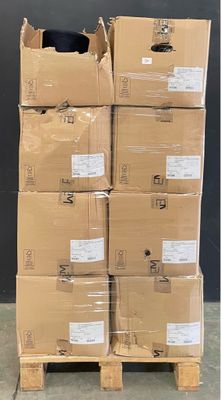 boxes stacked on pallets in a warehouse with a black wall in the background
