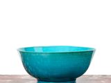 a blue bowl sitting on top of a marble table
