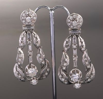 an image of a pair of diamond earrings on a stand