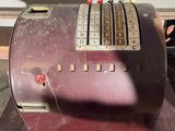 an old fashioned cash register sitting on a table