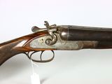 an old gun that is on display on a white surface