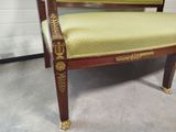 a chair with a green upholstered seat in a room