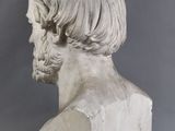 marble bust of a man with long hair and a beard