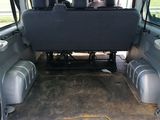 the back of a van with the seats folded down and the back of the van with the seats folded down