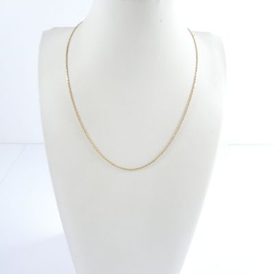 a gold chain necklace on a mannequin head