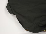 the back of a black backpack with a yellow zipper on it