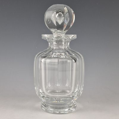 a clear glass bottle with a heart on the top