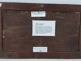 an old picture frame with a piece of paper on top of it