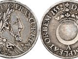 a silver coin with a crown on top of it