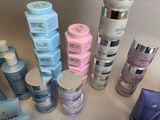 many different types of skin care products sitting on a table