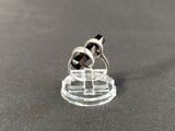 a small black and white ring on top of a clear stand