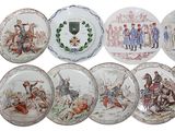 several plates with different designs of people on them on a white surface
