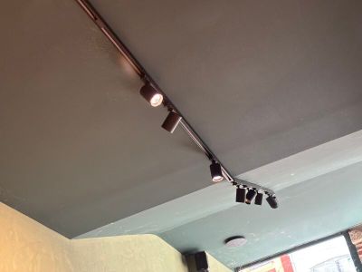 three spotlights that are on the ceiling of a restaurant