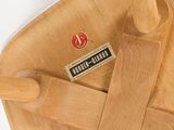 a close up of a wooden chair with a label on it