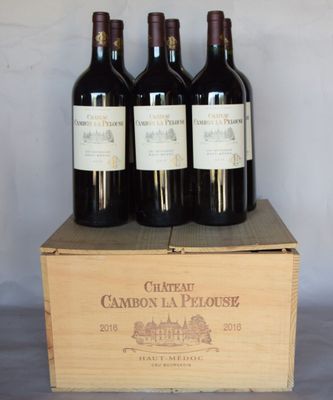 three bottles of wine are in a wooden box on a table