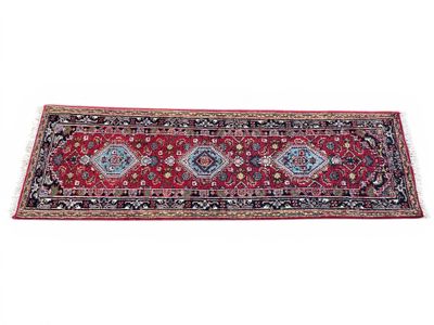 a red and black rug with a diamond design on it