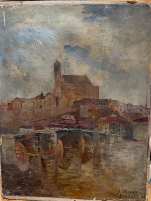 someone is holding up a painting of a city on a table
