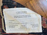 a close up of a label on a rug on a wooden floor